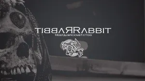 A photo of Rabbit Rabbit's logo, including rabbit in mirror image, and a pair of rabbits tousling.