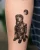 A dog in an astronaut suit tattoo by Edmonton tattoo artist Jent.