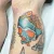 A blue skull holding a bowl of noodles tattoo by Edmonton tattoo artist Tony Honning.