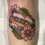 A floral cassette tape tattoo by Edmonton tattoo artist Justin Cats.